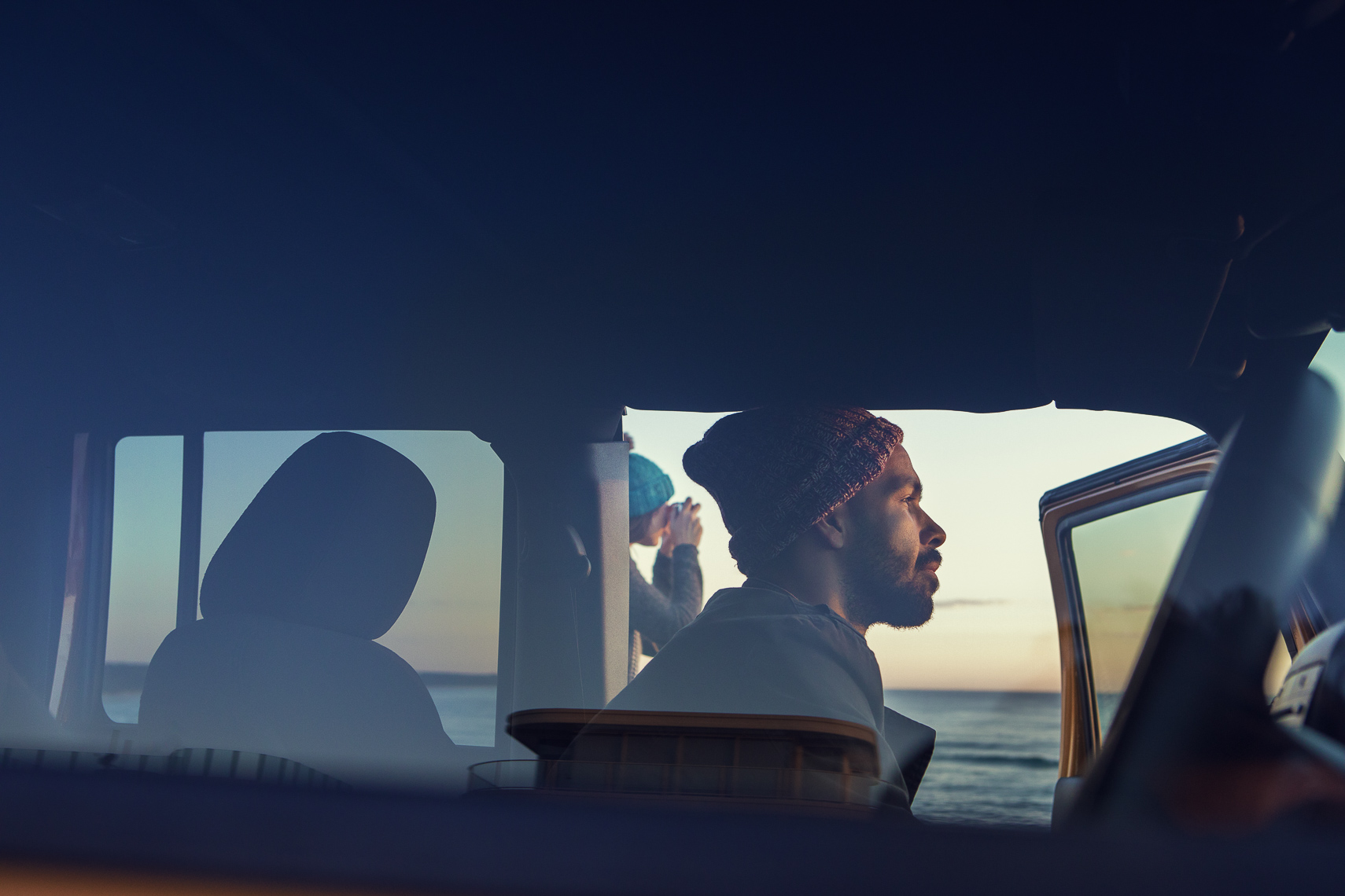 Two friends watching the sunrise in a car in Byron Bay