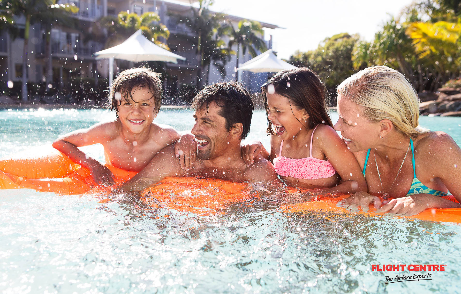 A young family splash and play in a pool on the gold coast