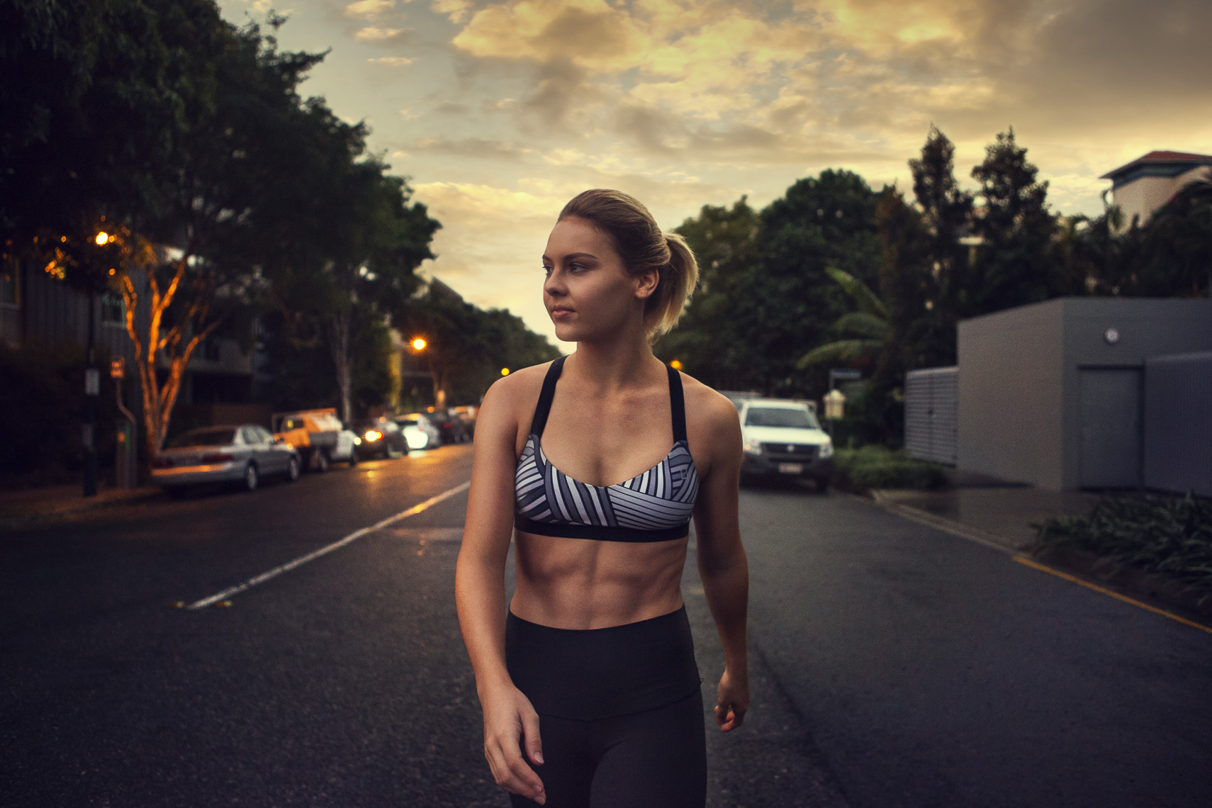 A girl walking as the sun rises in Brisbane during a photoshoot 