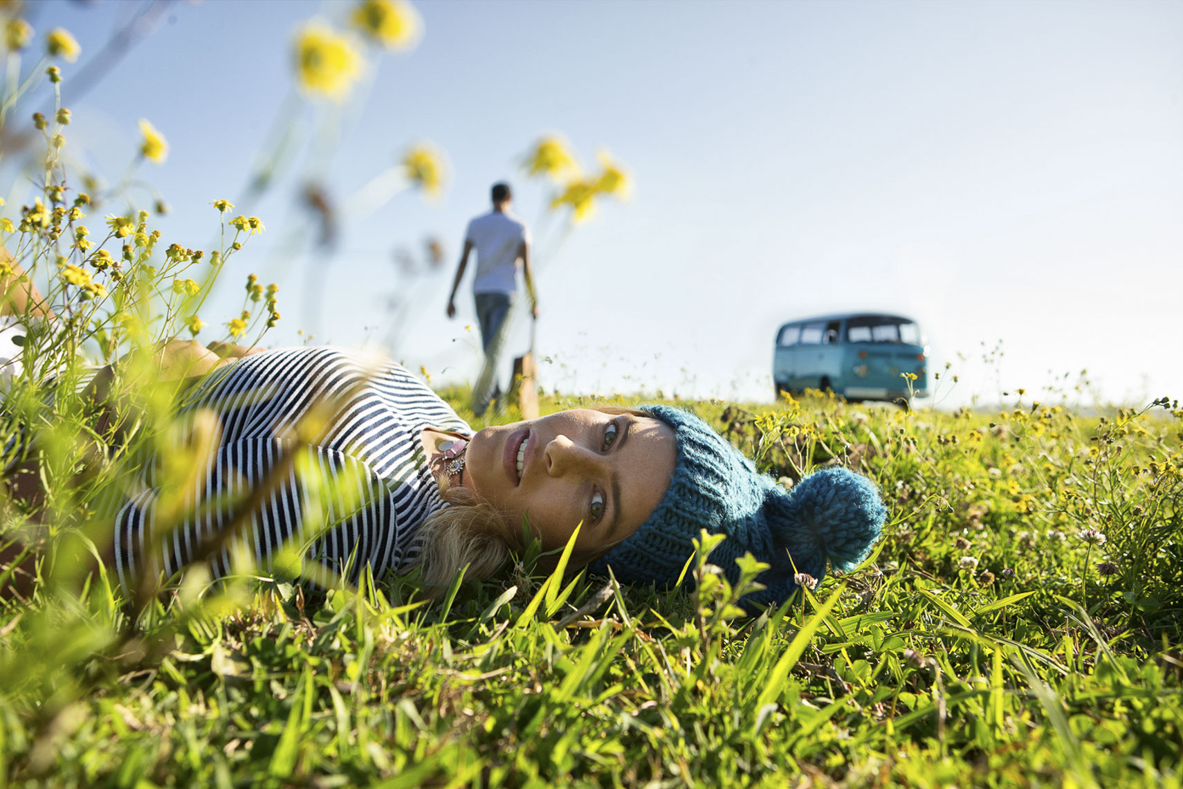 A girl laying in the grass looking at the camera for RACQ